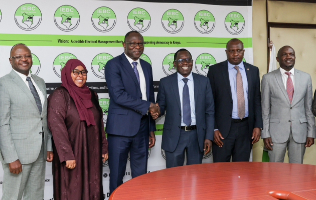 A file photo of IEBC Commissioners led by Chair Erastus Ethekon with Broadcasting PS Stephen Isaboke and MCK CEO David Omwoyo.